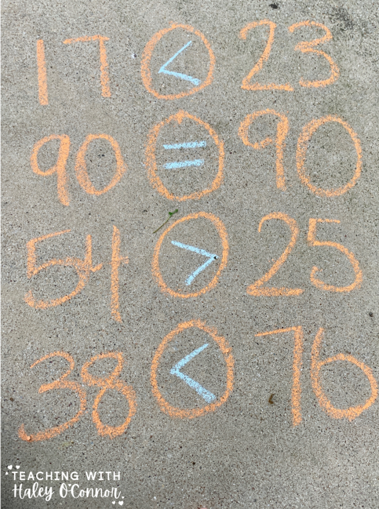 Number sense activities with chalk. Comparing numbers using greater than, less than, and equal then with chalk. 